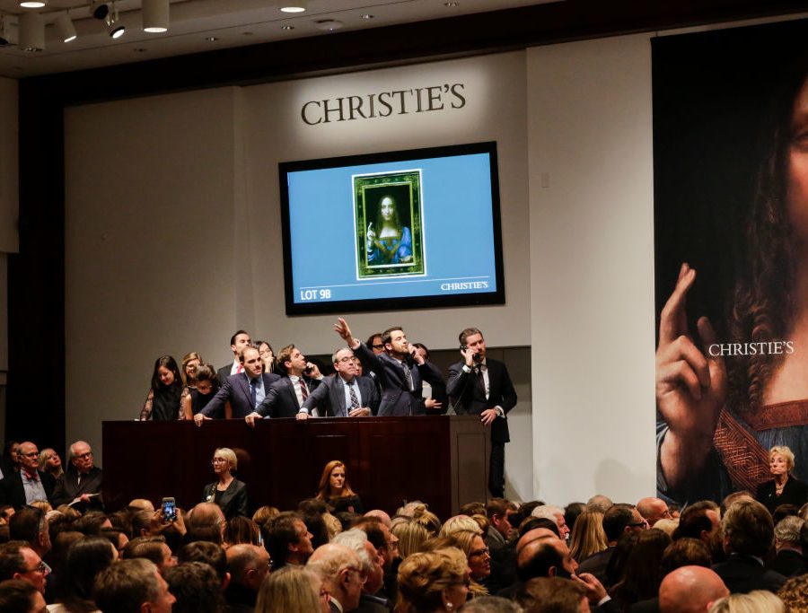 NEW YORK, NY - NOVEMBER 15: Agents speak on their phones with their clients while bidding on at the auction of Leonardo da Vinci's "Salvator Mundi" during the Post-War and Contemporary Art evening sale at Christie's on November 15, 2017 in New York City. The rediscovered masterpiece by the Renaissance master sells for an historic $450,312,500, obliterating the prevous world record for the most expensive work of art at auction. (Photo by Eduardo Munoz Alvarez/Getty Images)